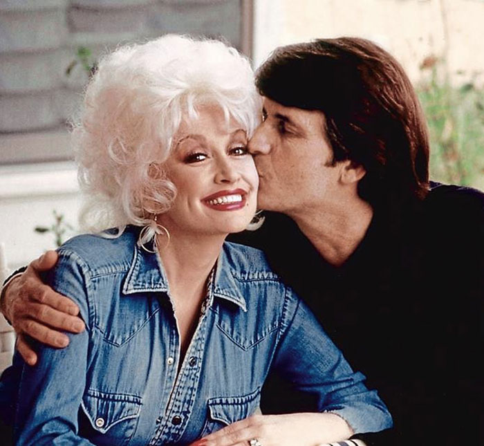 Couple embracing, one kissing the other on the cheek, in a warm moment. Couple embracing, one kissing the other on the cheek, in a warm moment.