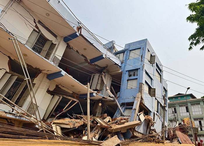 Collapsed building after Myanmar earthquake, highlighting nurses' heroic efforts to protect newborns. Collapsed building after Myanmar earthquake, highlighting nurses' heroic efforts to protect newborns.