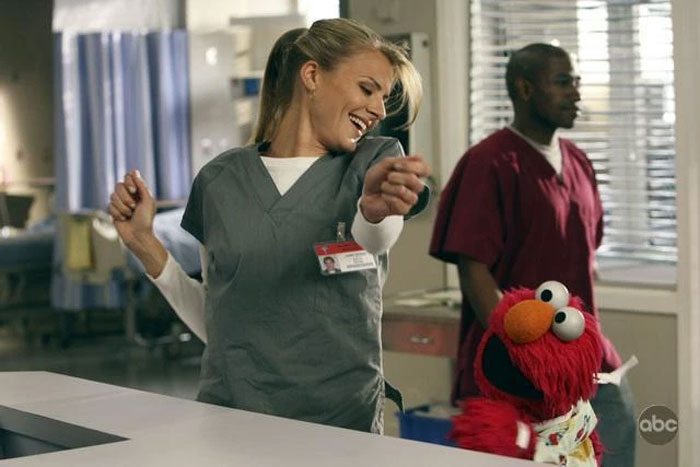 Scrubs star dancing with Elmo, wearing scrubs in a lively hospital setting. Scrubs star dancing with Elmo, wearing scrubs in a lively hospital setting.