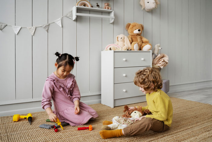 Children playing with toys in a cozy room, highlighting challenges of stepmom seeking bigger role in family dynamics. Children playing with toys in a cozy room, highlighting challenges of stepmom seeking bigger role in family dynamics.