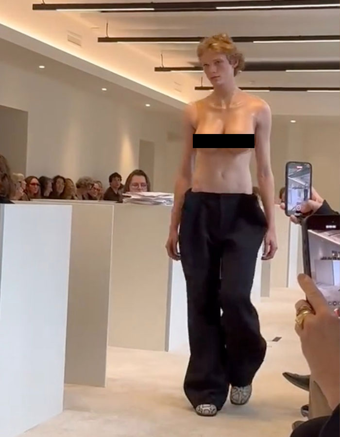 Model at Paris Fashion Week wearing bold male top imitating a female bare chest. Model at Paris Fashion Week wearing bold male top imitating a female bare chest.