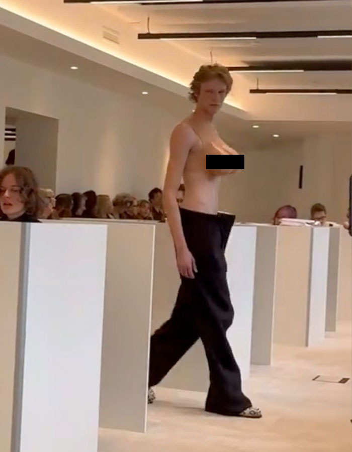 Model wearing a bold male top imitating a female chest at Paris Fashion Week runway show. Model wearing a bold male top imitating a female chest at Paris Fashion Week runway show.