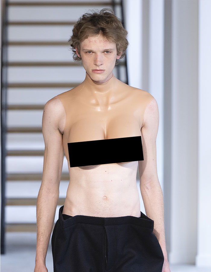 Male model in bold top resembling female chest at Paris Fashion Week. Male model in bold top resembling female chest at Paris Fashion Week.