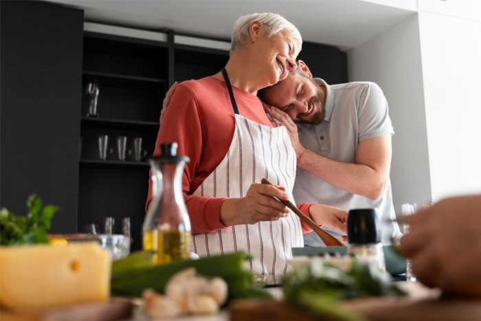 Man in kitchen with fiancée cooking Hispanic meal, sharing an intimate moment together. Man in kitchen with fiancée cooking Hispanic meal, sharing an intimate moment together.