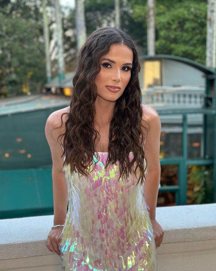 Young woman outside in a shimmering dress, context linked to viral flier refusing to give up seat. Young woman outside in a shimmering dress, context linked to viral flier refusing to give up seat.