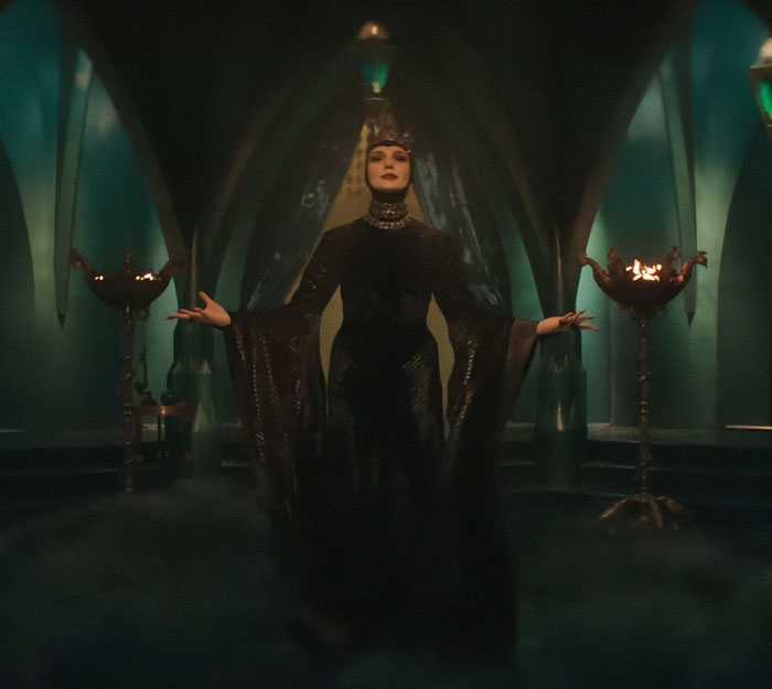 A character in a dark, dramatic setting, surrounded by mystical green light, related to Disney's 'Snow White' premiere. A character in a dark, dramatic setting, surrounded by mystical green light, related to Disney's 'Snow White' premiere.