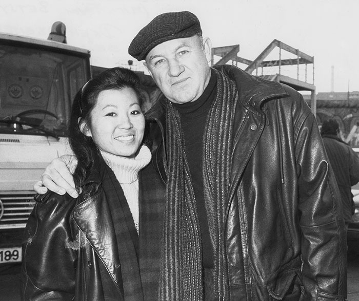 Man and woman in leather jackets, standing together in a black and white photo, related to Gene Hackman mystery. Man and woman in leather jackets, standing together in a black and white photo, related to Gene Hackman mystery.