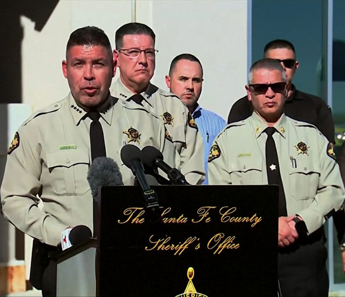 Sheriff's department at a press conference, discussing medical examiner's broken heart theory. Sheriff's department at a press conference, discussing medical examiner's broken heart theory.