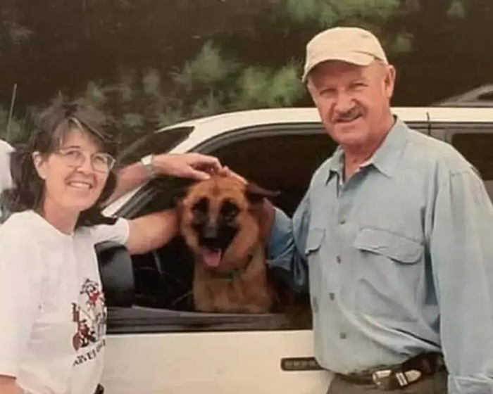 Gene Hackman smiling with a dog in a car. Gene Hackman smiling with a dog in a car.