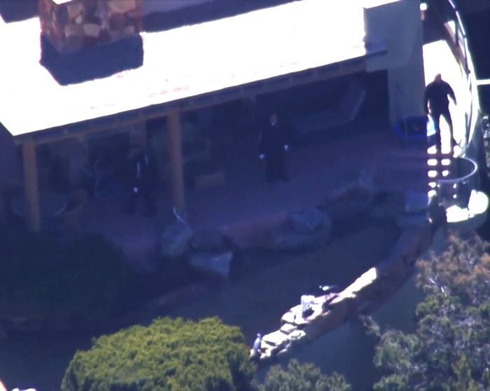 Aerial view of a house terrace with investigative personnel, related to a medical examiner's theory on broken heart-type conditions. Aerial view of a house terrace with investigative personnel, related to a medical examiner's theory on broken heart-type conditions.