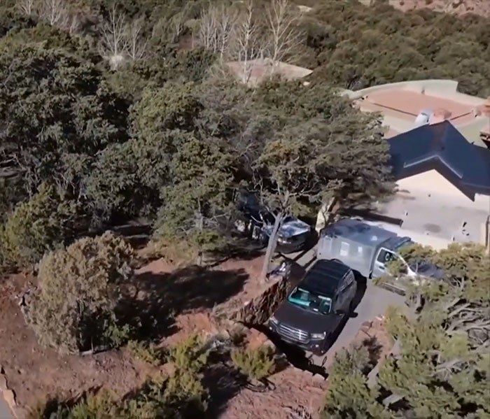 Aerial view of a house surrounded by trees with parked cars, related to Gene Hackman's passing. Aerial view of a house surrounded by trees with parked cars, related to Gene Hackman's passing.