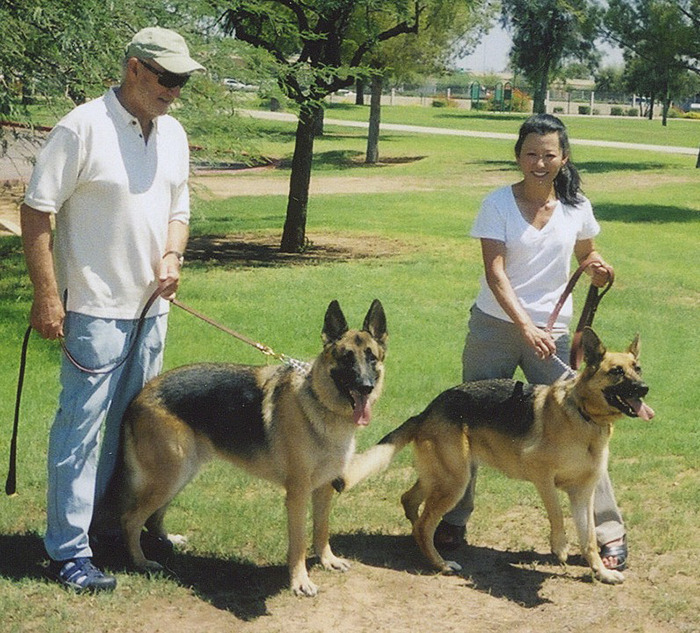 Gene Hackman and Betsy Arakawa walking dogs in a park. Gene Hackman and Betsy Arakawa walking dogs in a park.