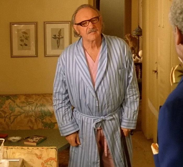 Man in a striped robe stands in a room during a discussion on "broken heart-type thing" theory. Man in a striped robe stands in a room during a discussion on "broken heart-type thing" theory.