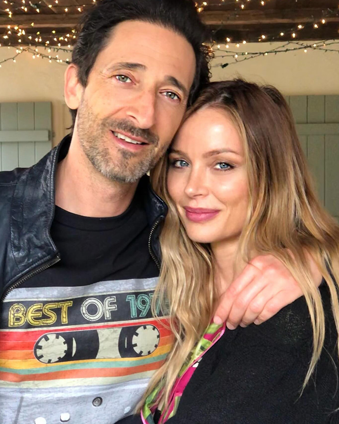 Georgina Chapman and Adrien Brody smiling together for a selfie. Georgina Chapman and Adrien Brody smiling together for a selfie.