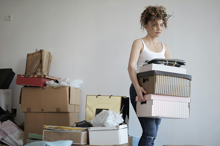 Woman quietly packing boxes, planning an exit after discovering infidelity. Woman quietly packing boxes, planning an exit after discovering infidelity.