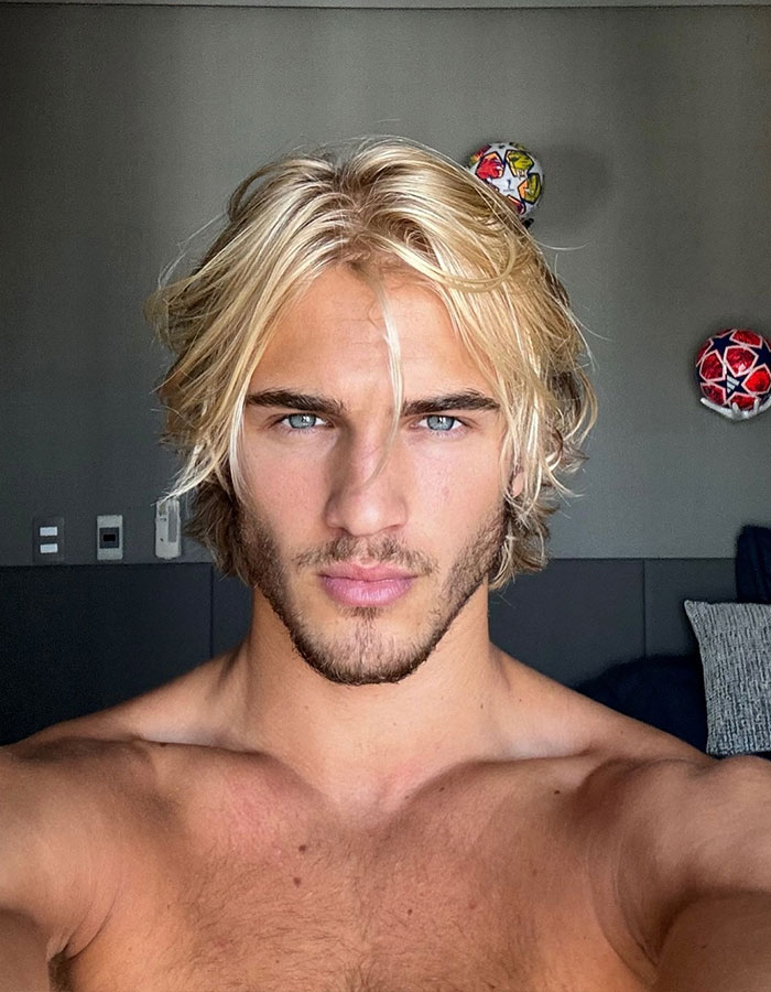 Blonde man with blue eyes, formerly "vain," transformed into a supermodel, showcasing his confident gaze. Blonde man with blue eyes, formerly "vain," transformed into a supermodel, showcasing his confident gaze.