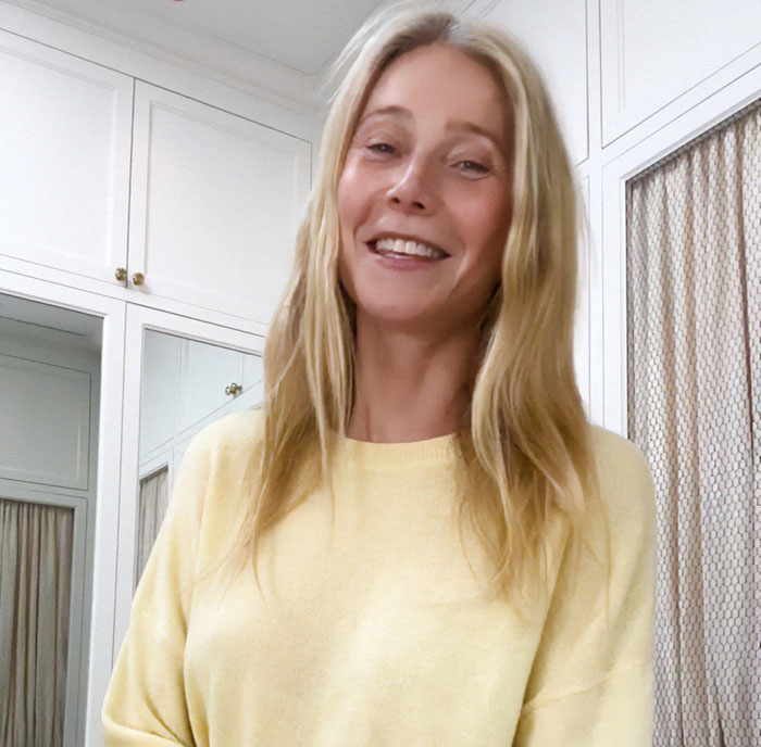 Blonde woman in a yellow sweater smiling, standing in a white room with cabinets, addressing feud rumors. Blonde woman in a yellow sweater smiling, standing in a white room with cabinets, addressing feud rumors.