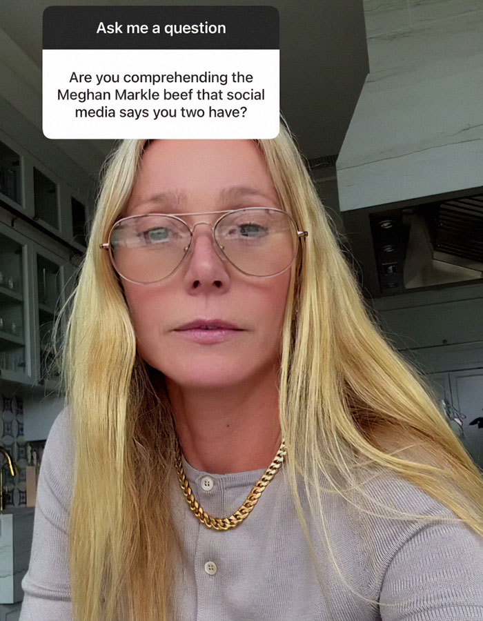 Blonde woman with glasses and gold chain responds to Meghan Markle feud rumors in a casual setting. Blonde woman with glasses and gold chain responds to Meghan Markle feud rumors in a casual setting.