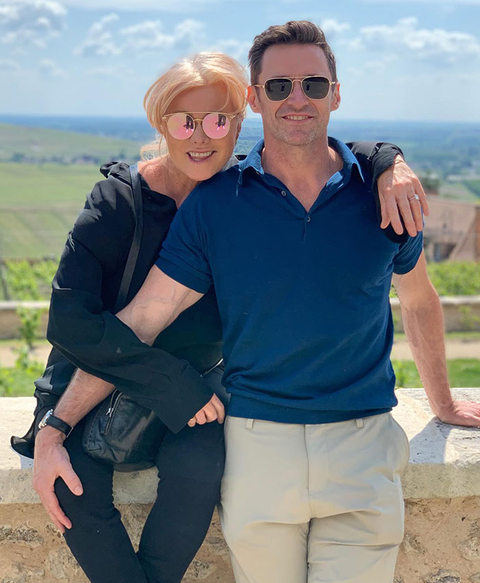 Couple smiling outdoors with sunglasses, arms around each other amid divorce news. Couple smiling outdoors with sunglasses, arms around each other amid divorce news.