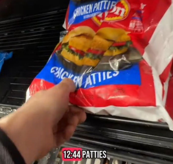 Close-up of a hand holding a bag of chicken patties, highlighting grocery prices in the US. Close-up of a hand holding a bag of chicken patties, highlighting grocery prices in the US.