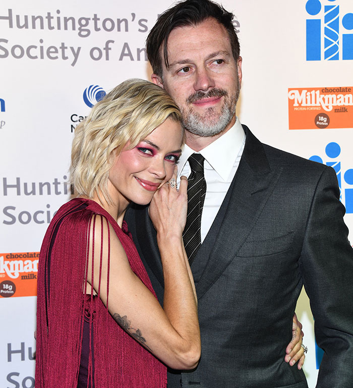A woman in a red dress poses with a man in a suit at an event, related to Taylor Swift's godson court news. A woman in a red dress poses with a man in a suit at an event, related to Taylor Swift's godson court news.