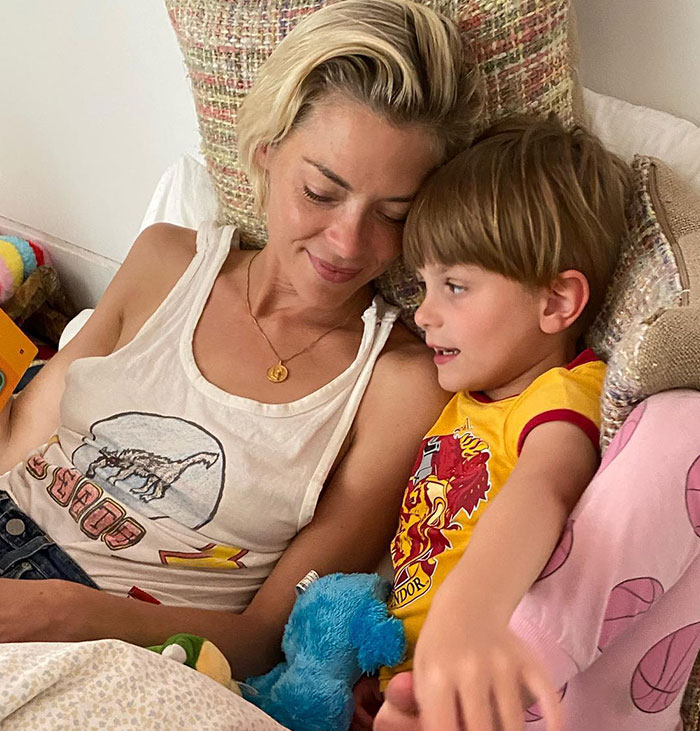 Woman and child smiling in bed, related to Taylor Swift's godson court news. Woman and child smiling in bed, related to Taylor Swift's godson court news.