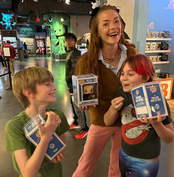 Woman and two kids smiling in a store with collectible toys, related to Taylor Swift's godson news. Woman and two kids smiling in a store with collectible toys, related to Taylor Swift's godson news.
