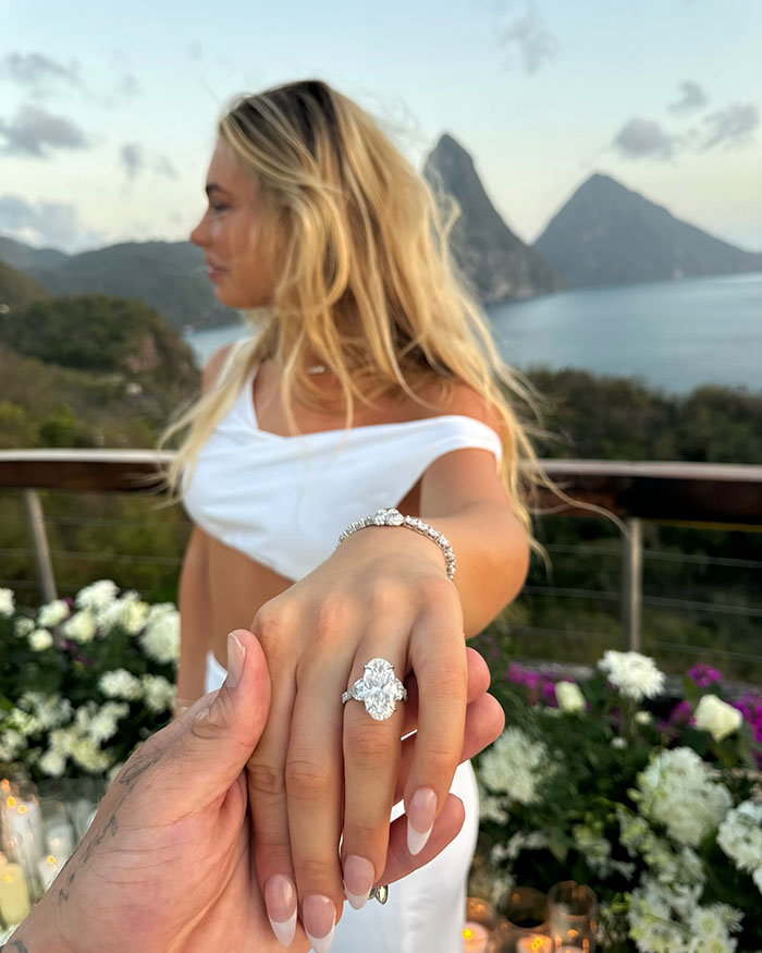 Woman showing engagement ring with scenic mountains in the background. Woman showing engagement ring with scenic mountains in the background.