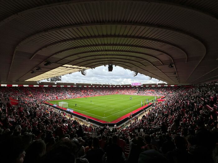 Soccer stadium filled with fans watching a match on the pitch, showcasing one of the cathedrals of soccer and legendary moments.