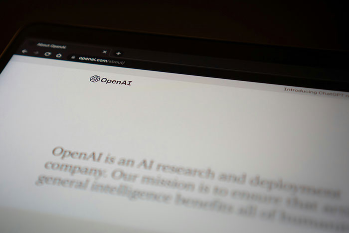 OpenAI webpage displayed on a laptop screen, highlighting AI's impact on the environment. OpenAI webpage displayed on a laptop screen, highlighting AI's impact on the environment.