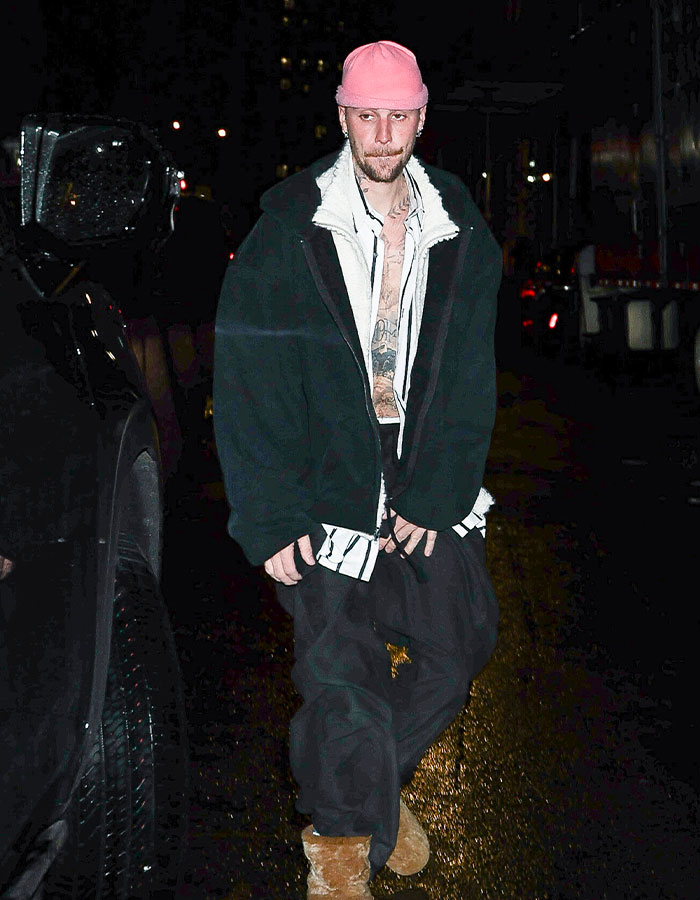 Person wearing a pink cap and black jacket walking at night, touching on impostor syndrome themes in recent news. Person wearing a pink cap and black jacket walking at night, touching on impostor syndrome themes in recent news.