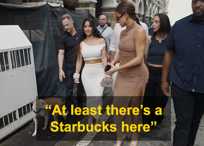 Kim Kardashian walking with a group, surprised by surroundings, with text overlay about Starbucks, in an urban street setting. Kim Kardashian walking with a group, surprised by surroundings, with text overlay about Starbucks, in an urban street setting.