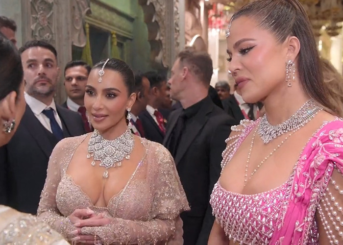 Two women in elegant dresses at a formal event, surrounded by people, conversation and luxury ambiance. Two women in elegant dresses at a formal event, surrounded by people, conversation and luxury ambiance.