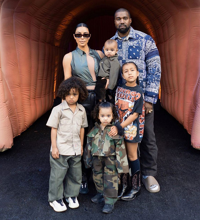 Family photo with Kim K, Kanye, and kids in casual clothes, related to Dr. Phil's foster care warning. Family photo with Kim K, Kanye, and kids in casual clothes, related to Dr. Phil's foster care warning.