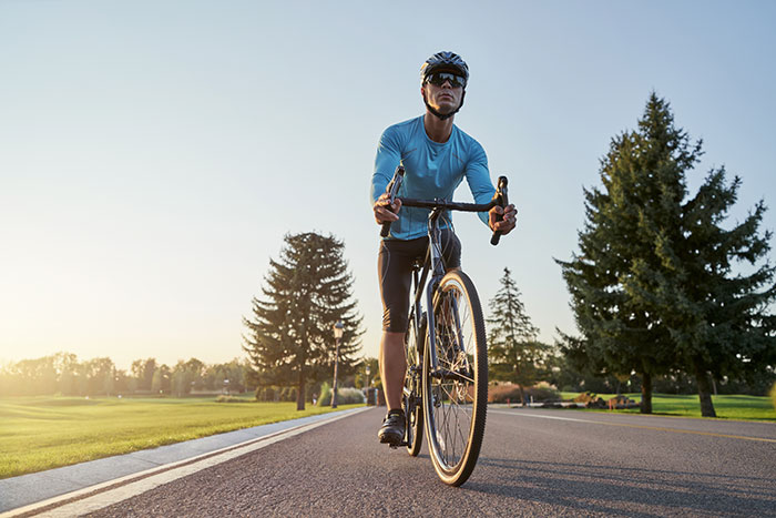 Man cycling in the park, illustrating weight loss and lifestyle transformation benefits. Man cycling in the park, illustrating weight loss and lifestyle transformation benefits.
