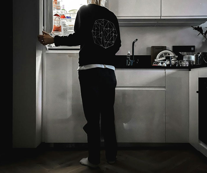 Person standing in a kitchen, opening the fridge, hiding stuffed cheese bread with meat from roommates. Person standing in a kitchen, opening the fridge, hiding stuffed cheese bread with meat from roommates.