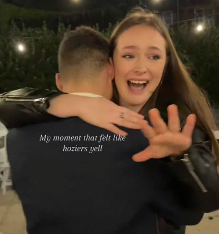 Engaged couple embraces at a wedding, woman reacts excitedly to surprise proposal. Engaged couple embraces at a wedding, woman reacts excitedly to surprise proposal.