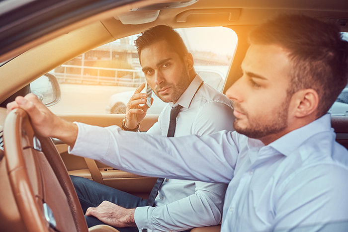 Two men in a car, one is driving, illustrating free ride to work scenario. Two men in a car, one is driving, illustrating free ride to work scenario.