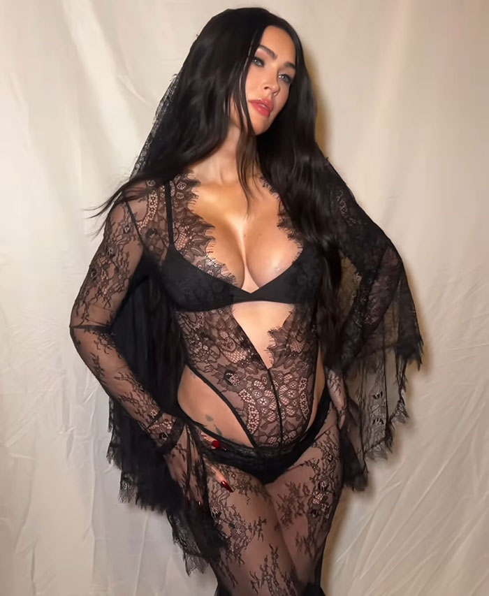 Black lace outfit with a sheer layer, posing against a neutral backdrop. Celestial Seed theme sparks name confusion. Black lace outfit with a sheer layer, posing against a neutral backdrop. Celestial Seed theme sparks name confusion.