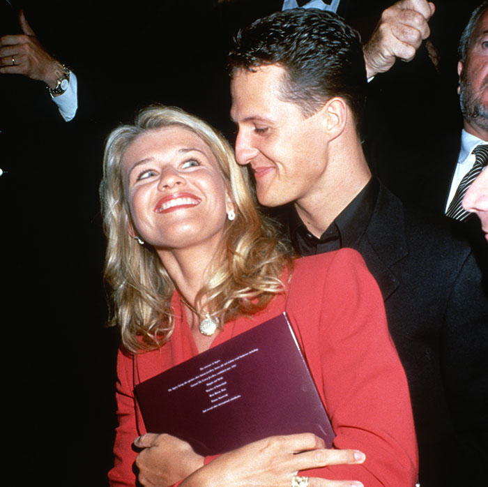 Man and woman smiling together at an event. Main SEO keyword: Michael Schumacher. Man and woman smiling together at an event. Main SEO keyword: Michael Schumacher.