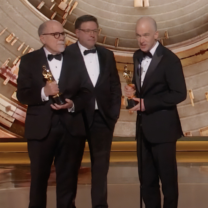 Best Sound winners in tuxedos holding Oscars on stage. Best Sound winners in tuxedos holding Oscars on stage.