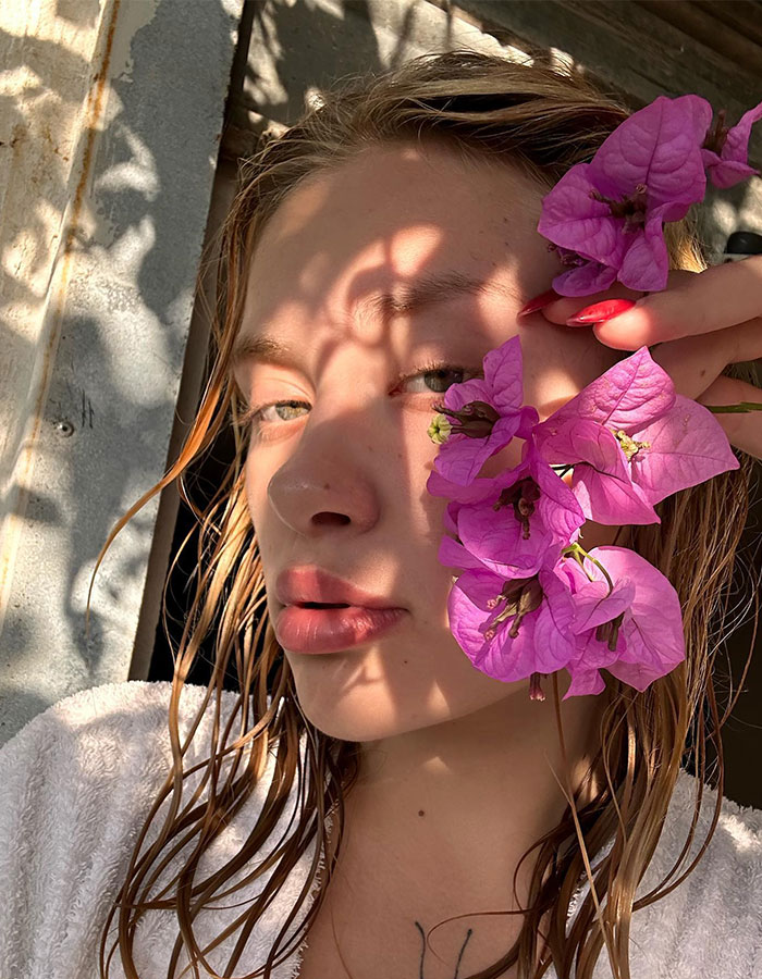 Model with wet hair, wrapped in a towel, holding pink flowers, related to assault case investigation and "Porta Potty" parties. Model with wet hair, wrapped in a towel, holding pink flowers, related to assault case investigation and "Porta Potty" parties.