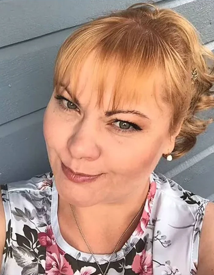 A woman with red hair in a floral top, relevant to model trafficking at parties investigation. A woman with red hair in a floral top, relevant to model trafficking at parties investigation.