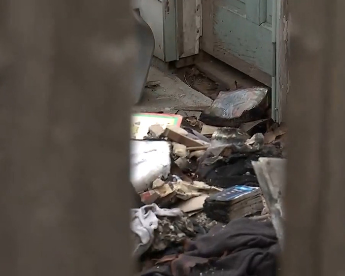 Charred debris inside a damaged room, highlighting the aftermath of a fire escape incident tied to alleged imprisonment. Charred debris inside a damaged room, highlighting the aftermath of a fire escape incident tied to alleged imprisonment.