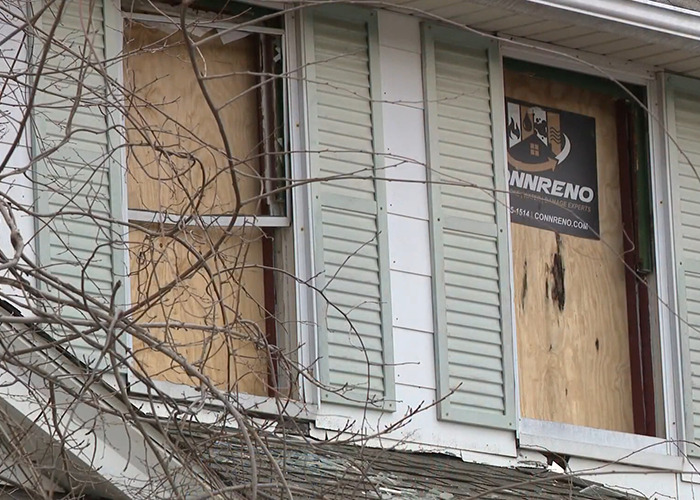 Boarded windows of a house where a stepson allegedly imprisoned for decades set fire to escape. Boarded windows of a house where a stepson allegedly imprisoned for decades set fire to escape.