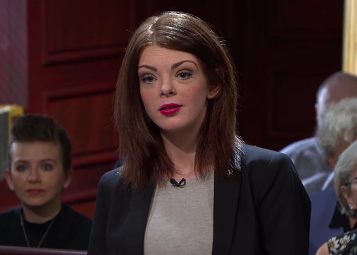 Woman speaking in a courtroom setting linked to UK expats and benefits advice. Woman speaking in a courtroom setting linked to UK expats and benefits advice.