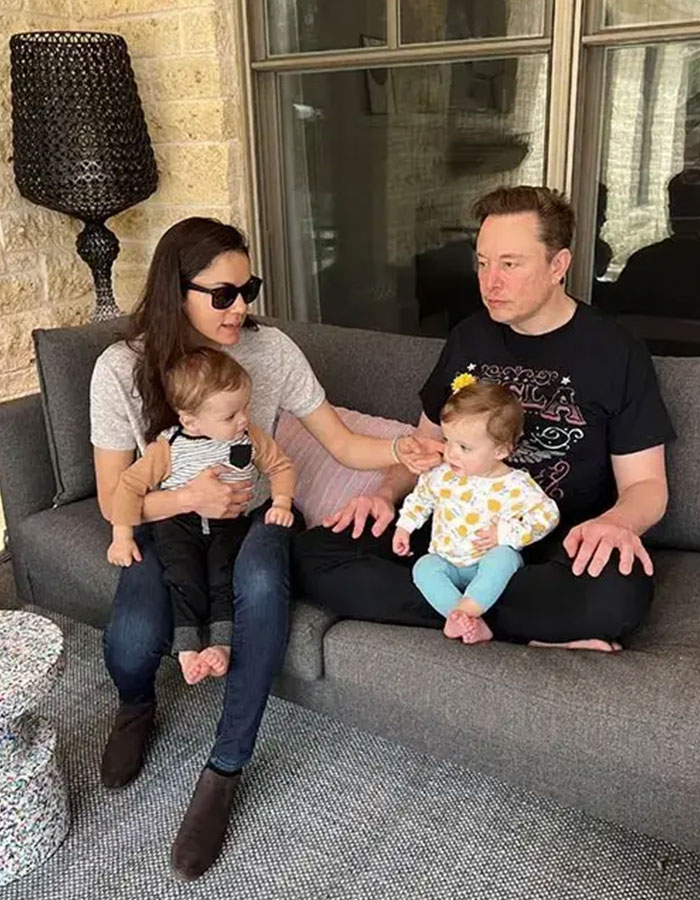 Man and woman on a couch with two babies, highlighting family and children. Man and woman on a couch with two babies, highlighting family and children.