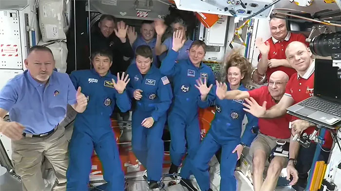 SpaceX Crew on ISS mission waving, ready to bring stranded NASA astronauts back home, celebrating teamwork in the station. SpaceX Crew on ISS mission waving, ready to bring stranded NASA astronauts back home, celebrating teamwork in the station.