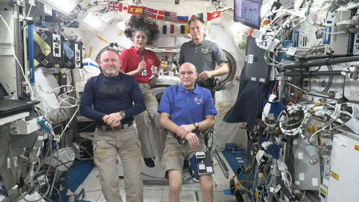 SpaceX crew arrives at ISS to assist stranded NASA astronauts, seated in the space station interior with equipment in view. SpaceX crew arrives at ISS to assist stranded NASA astronauts, seated in the space station interior with equipment in view.
