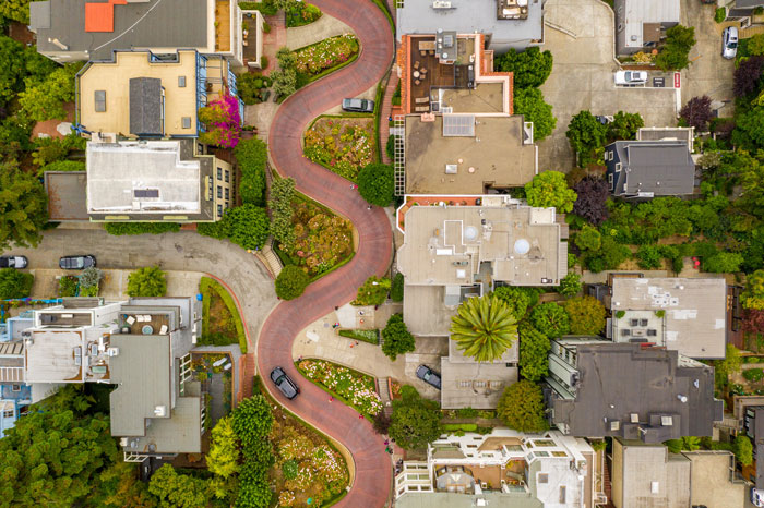 Aerial view of neighborhood with winding road, showcasing potential setup area by a mom for her 'catch' of a son. Aerial view of neighborhood with winding road, showcasing potential setup area by a mom for her 'catch' of a son.